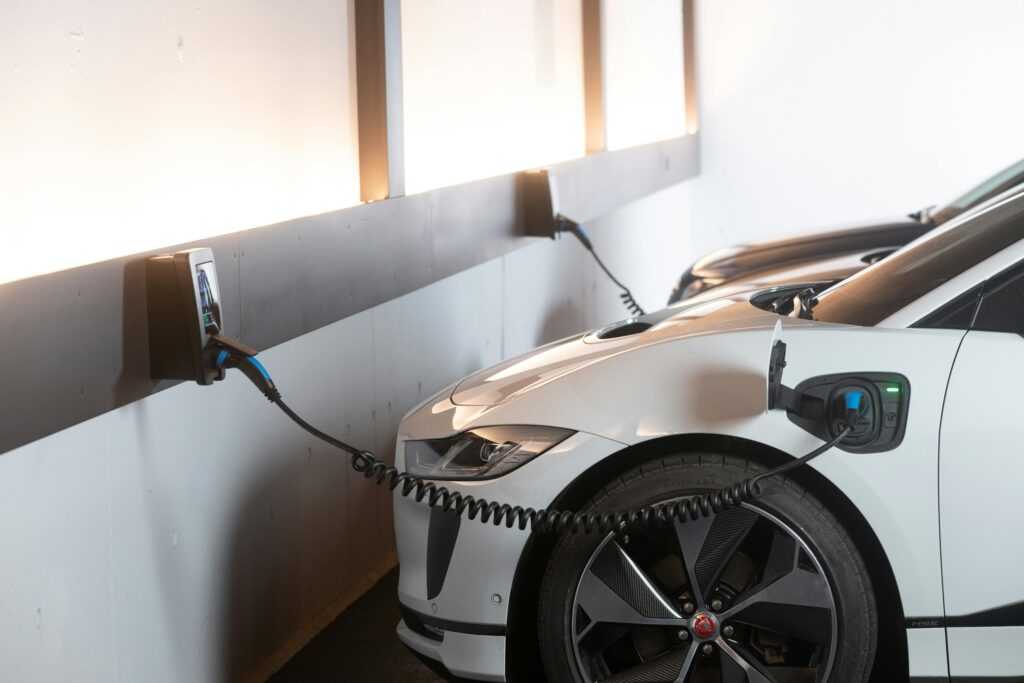 Electric car charging in a modern indoor station promoting sustainability and energy efficiency.